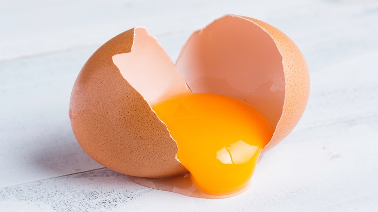 A raw egg with cracked shell