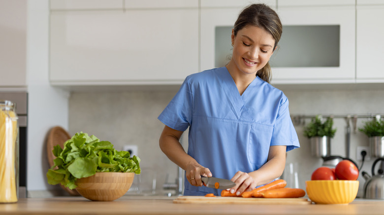 cutting carrots to make coleslaw