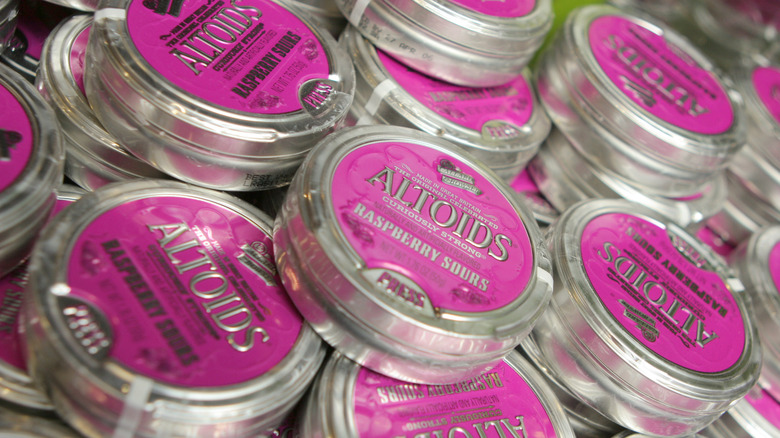 Altoids Raspberry sours tins stacked in a pile