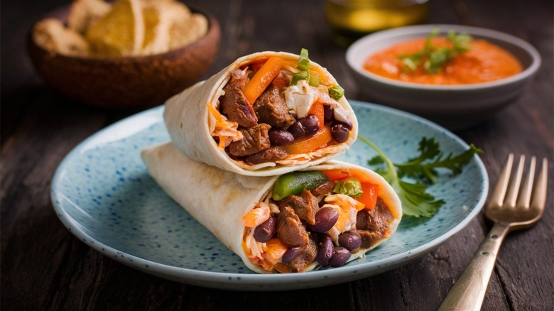 A burrito with beans and vegetables