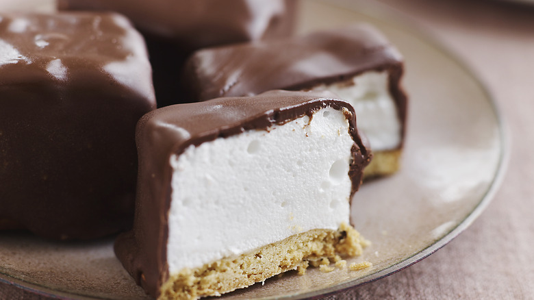 A plate of chocolate covered marshmallows