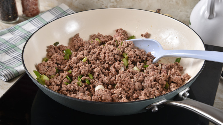 spoon in pan of ground beef