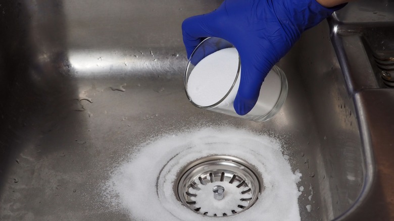 sprinkling baking soda in sink