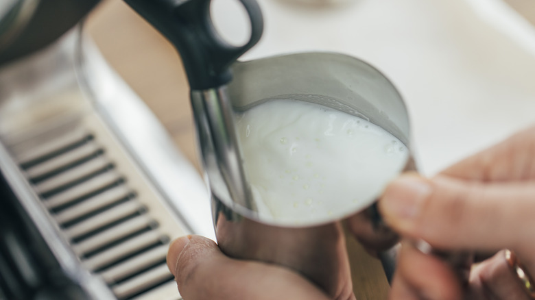 A barista steaming milk