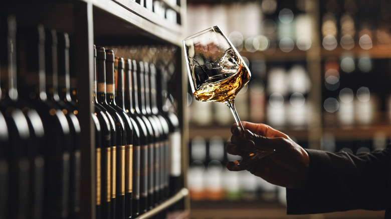 sommelier swirling glass of white wine