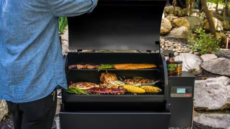 A person cooking over the Traeger Pro 780