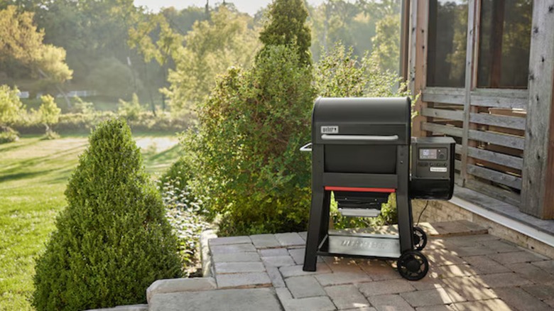 A Weber grill on a backyard patio