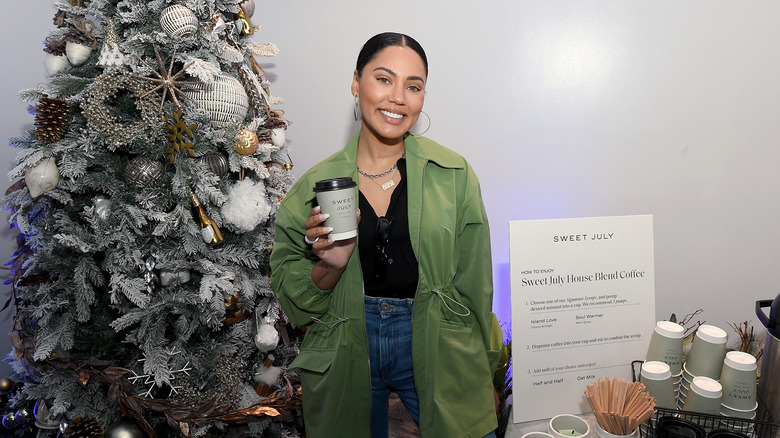 Ayesha Curry holding a hot coffee