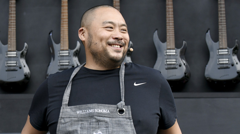 David Chang in front of guitars