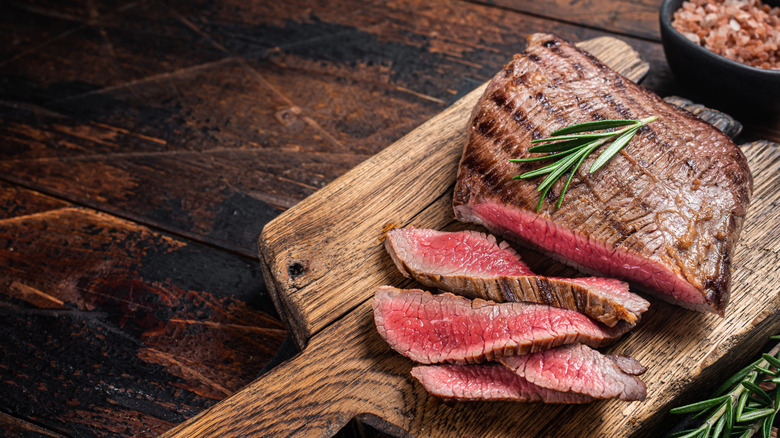 Grilled flank steak garnished with rosemary