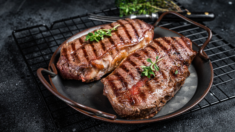 Two flat iron steaks in a copper pan