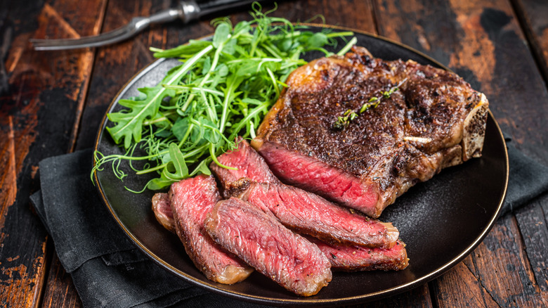 Sliced steak and rocket on a plate