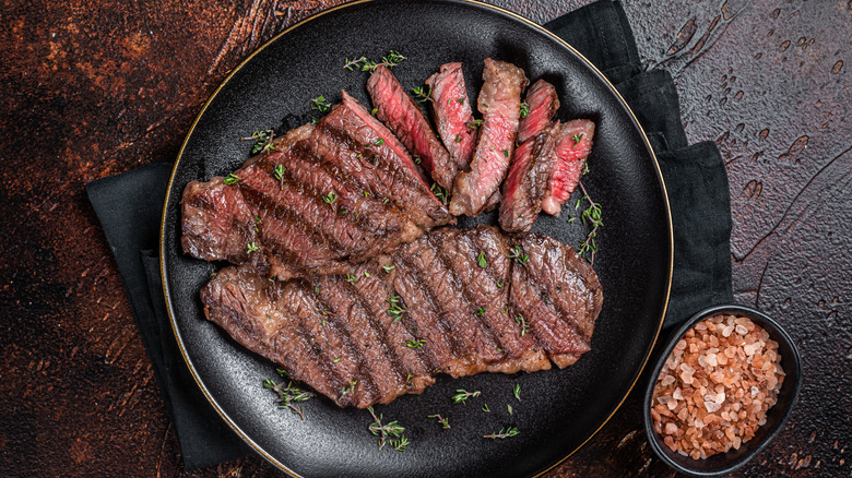 Sliced Denver steak with pink Himalayan salt