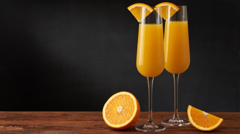 mimosas in flutes with oranges