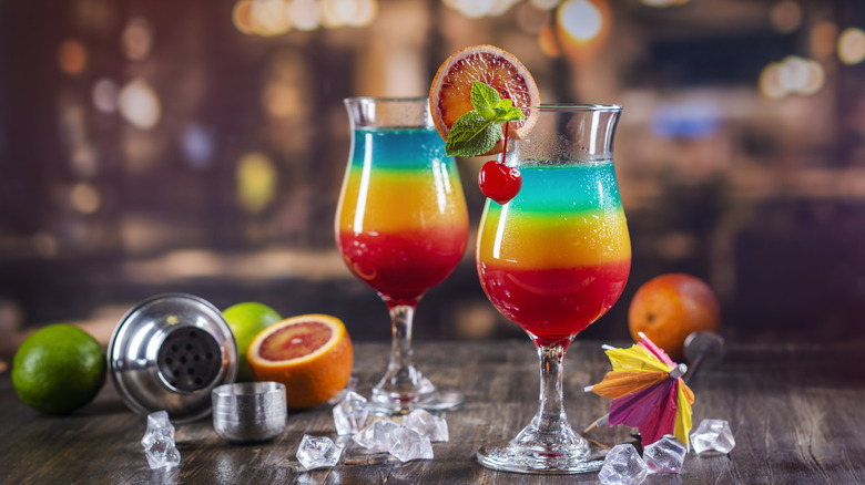 Colorful cocktails in hurricane glasses