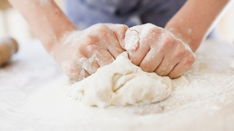 hands kneading bread