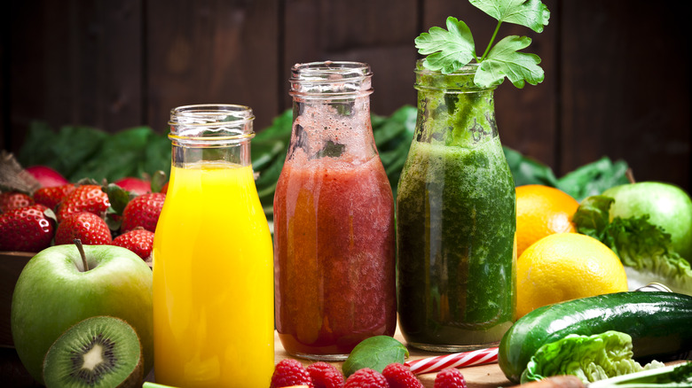 fruits and veggies around smoothie jars