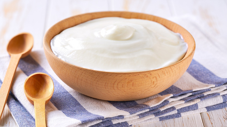 A wooden bowl of yogurt