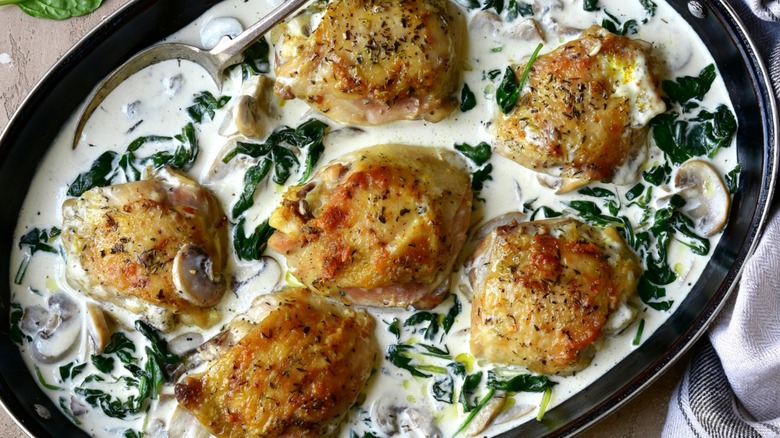 Chicken thighs in a white sauce with spinach