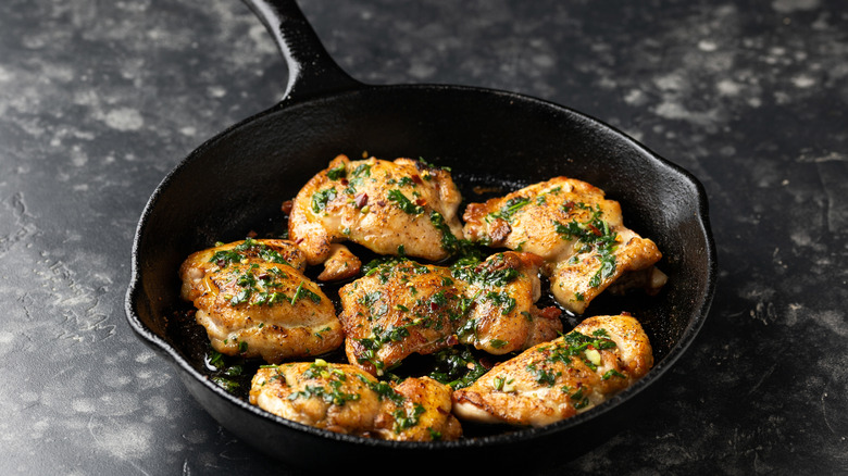 Cooked chicken thighs in a cast iron pan