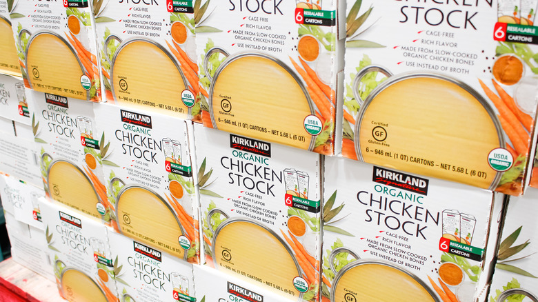 a stack of cases of kirkland signature organic chicken stock