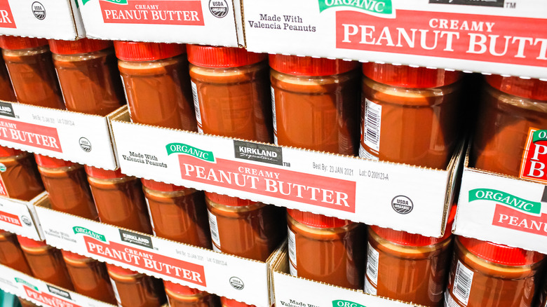 stacks of kirkland peanut butter jars at Costco