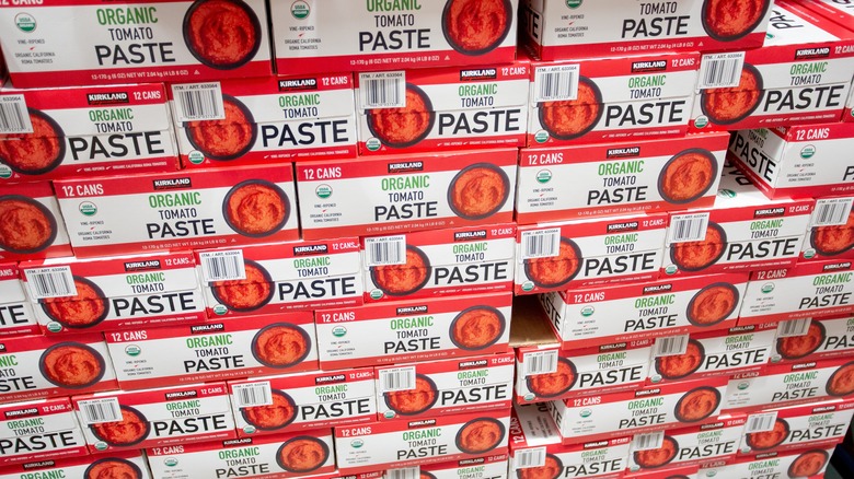 stacks of kirkland signature tomato paste in boxes