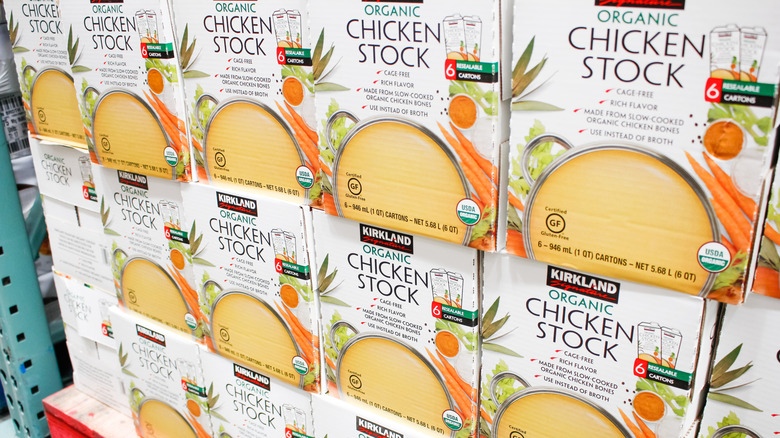 a stack of cases of kirkland signature organic chicken stock