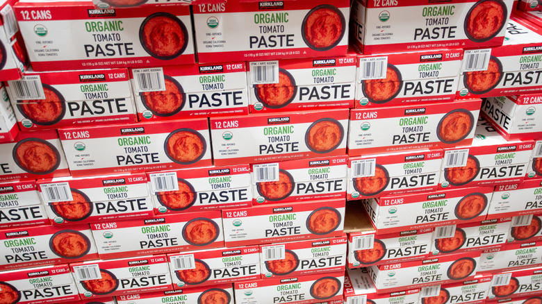 stacks of kirkland signature tomato paste in boxes