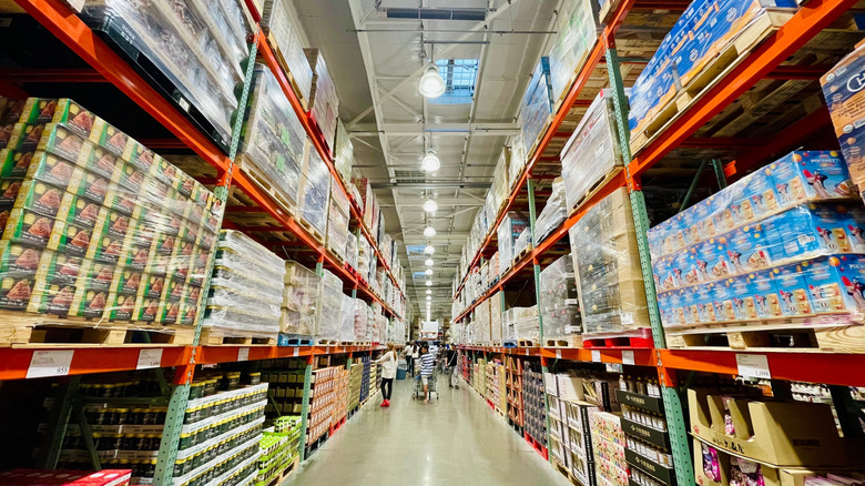 a huge Costco aisle with shoppers meandering through