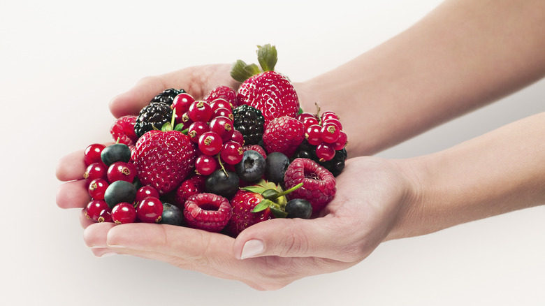 A hand filled with berries
