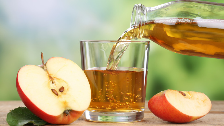 pouring apple juice into a glass