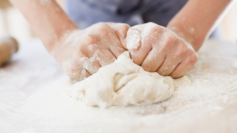 Hands kneading bread dough