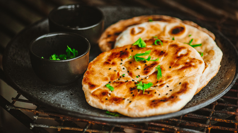 Naan bread garnished with herbs
