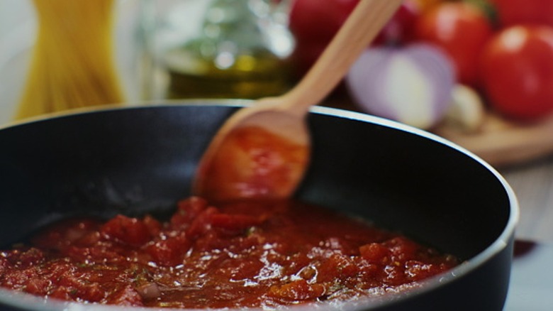 stirring tomato sauce