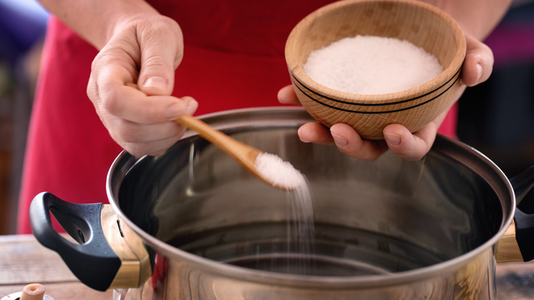 salting water in pot