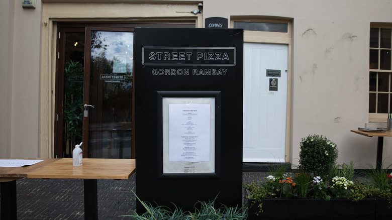 A picture of a takeaway menu outside Gordon Ramsay's Street Pizza restaurant in London