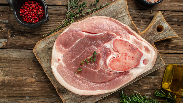 fresh pork on a wooden chopping board