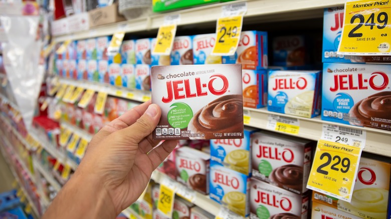 hand holding pudding mix at store