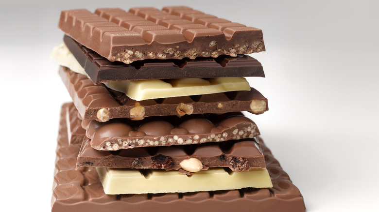 many different types of chocolate bars stacked