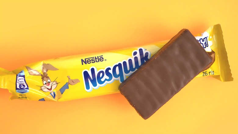 A Nesquik candy on yellow wrapper