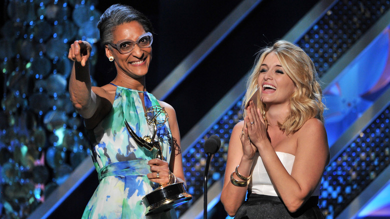 Carla Hall holding an Emmy Award