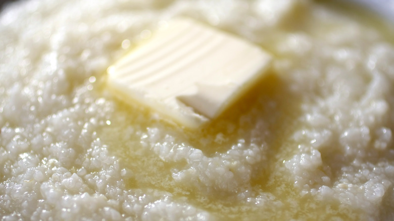 close up of grits topped with butter 