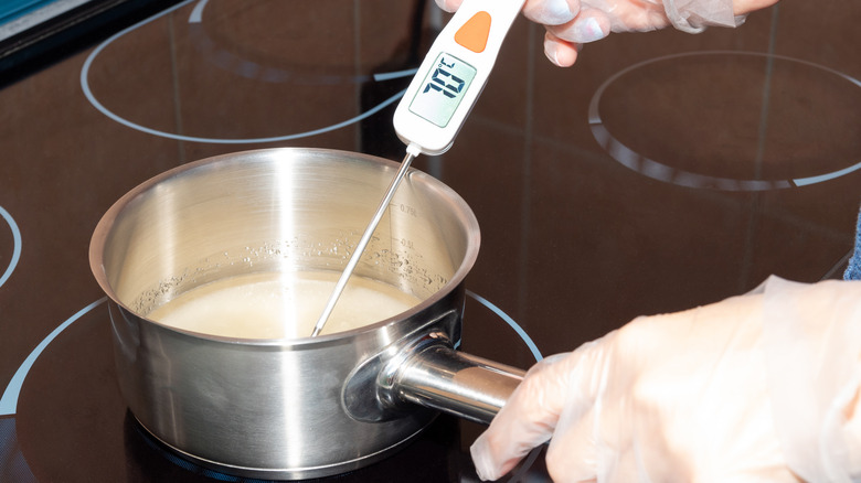 Person cooking with a candy thermometer