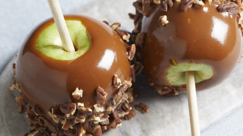 two caramel apples on table