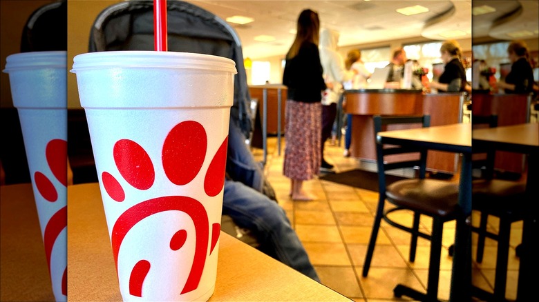 A Chick-fil-A cup on table in a restaurant