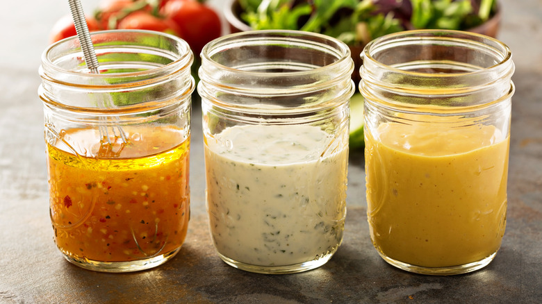 Three jars of homemade salad dressing