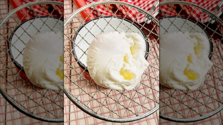 draining a poached egg