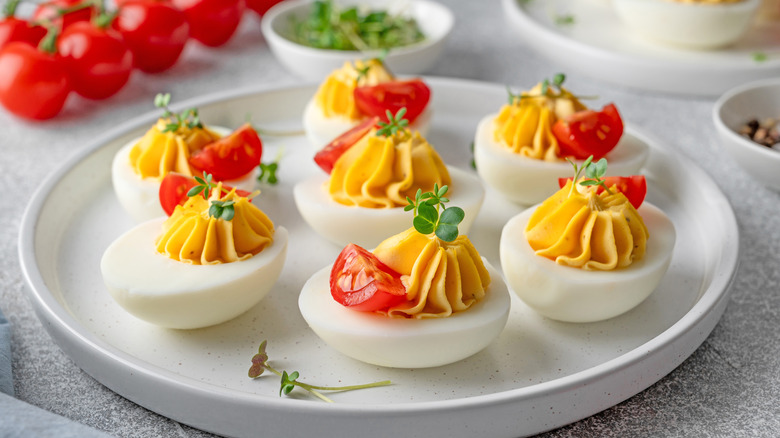 Deviled eggs garnished with tomatoes