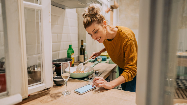 A person checking a recipe when cooking